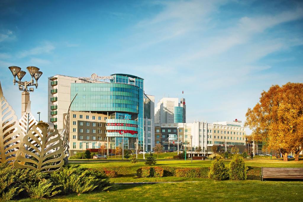 a view of a city with a park and buildings at Victoria Hotel & Business centre Minsk in Minsk
