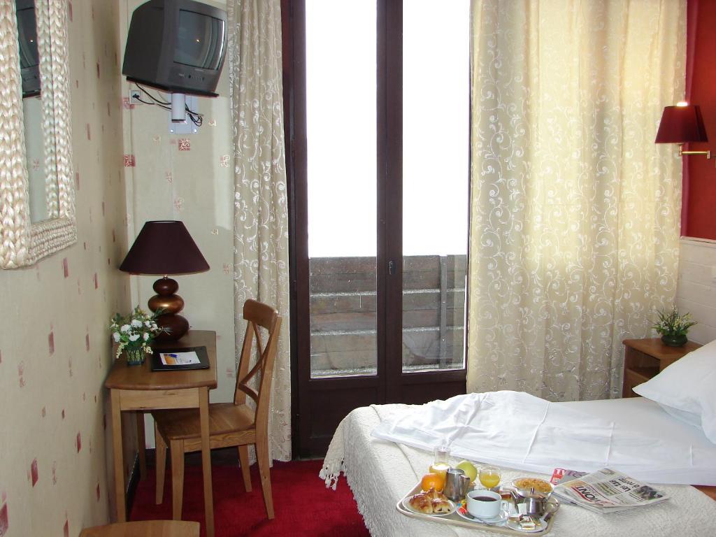 Postel nebo postele na pokoji v ubytování Le Grand Hôtel de Besse