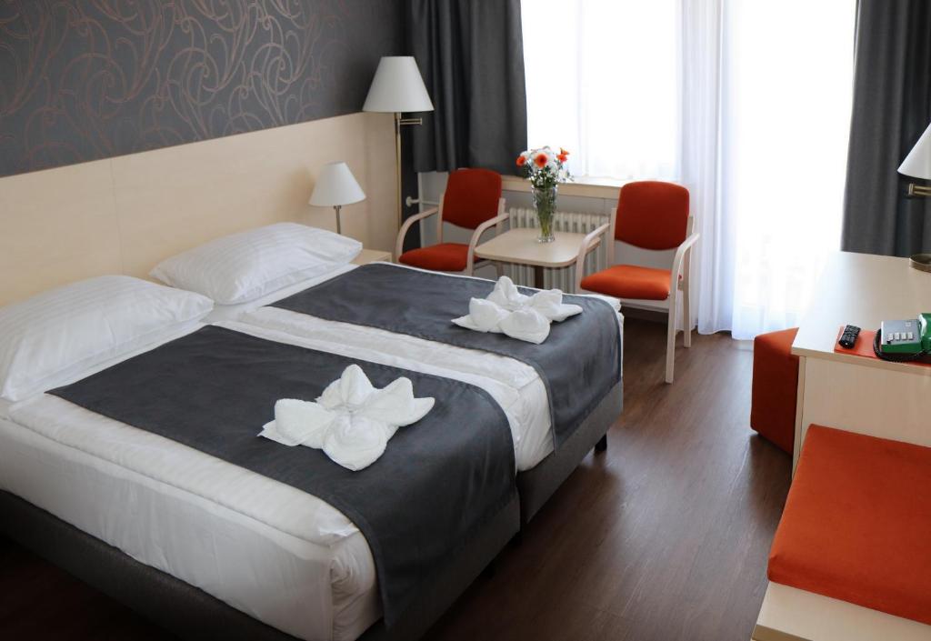 Postel nebo postele na pokoji v ubytování Hotel Krystal