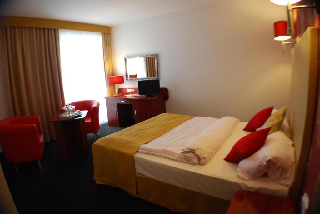 Postel nebo postele na pokoji v ubytování Amigo Hotel