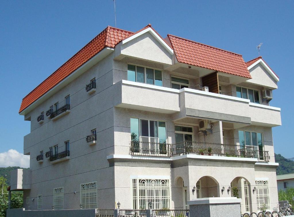 a large building with a red roof at Star 101 Guest House in Taitung City