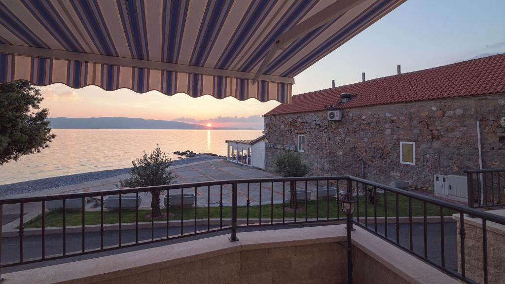 a balcony with a view of the water at Dida moj in Senj