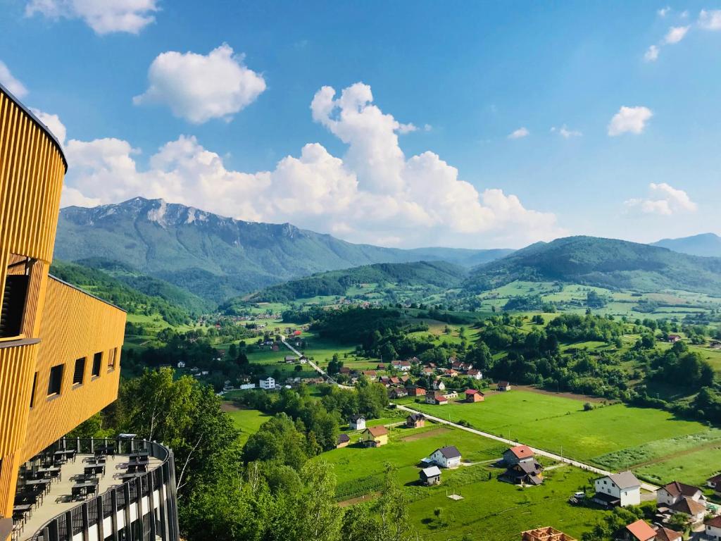 a view of a village in a valley with mountains at Tarcin Forest Resort and Spa MGallery by Sofitel in Tarčin