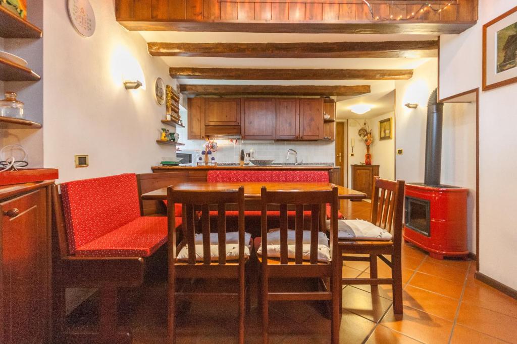 a kitchen with a table and chairs in a kitchen at Casa Silva in Falcade