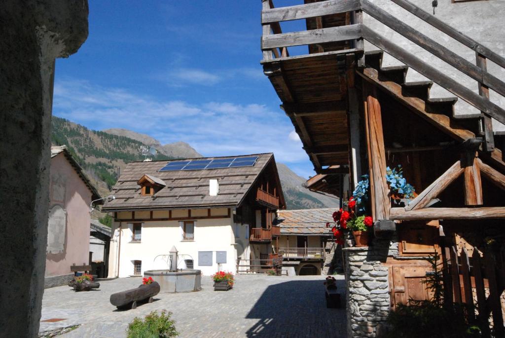 a building with a roof with solar panels on it at Baita della Fontana in Pragelato