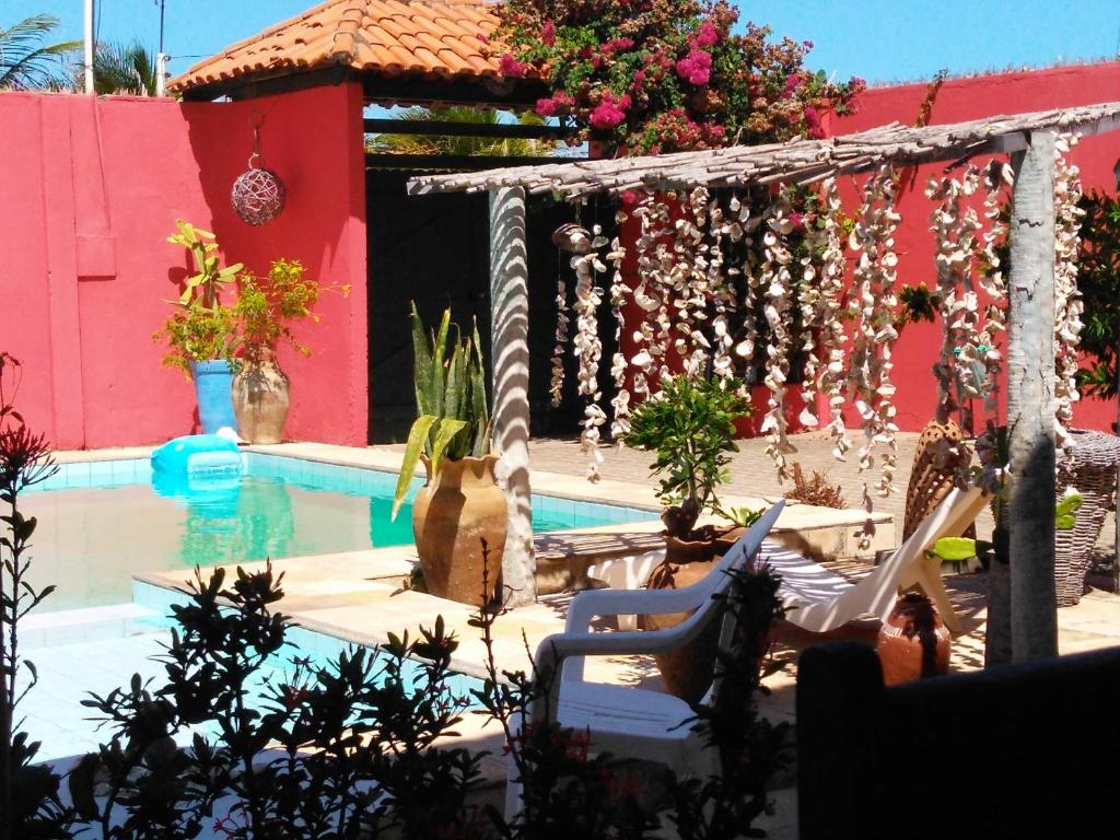 a swimming pool with a chair next to a house at Bed & Breakfast Casa de Valeria in Barra Nova