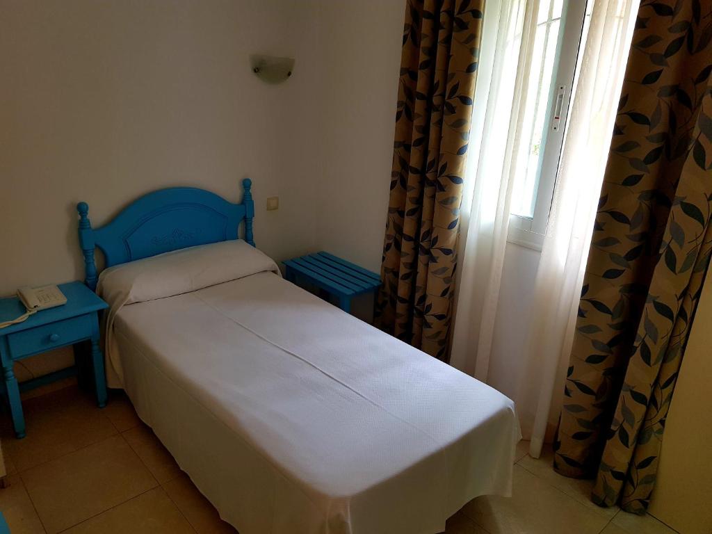 Postel nebo postele na pokoji v ubytování Hotel Eliseos
