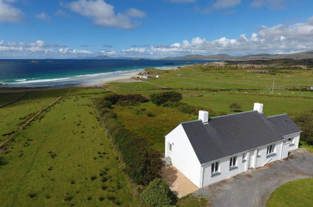 an aerial view of a white house on the beach at Cottage 202 - Renvyle in Renvyle