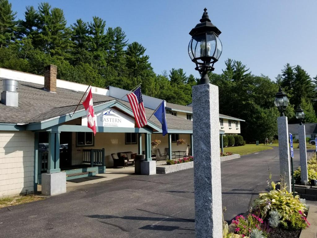 a street light in front of a building with flags at Eastern Inn & Suites (formerly Eastern Inns) in North Conway