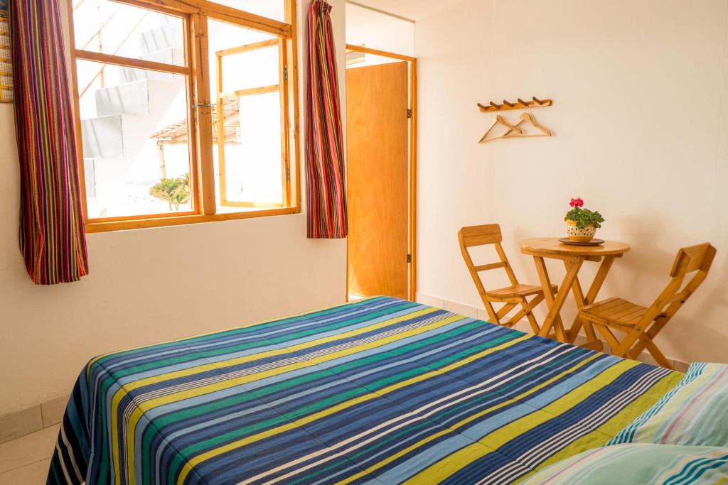 Postel nebo postele na pokoji v ubytování Cruz del Sur