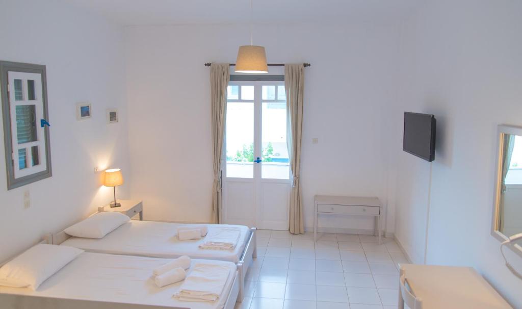 Ένα ή περισσότερα κρεβάτια σε δωμάτιο στο Ostria Hotel & Apartments