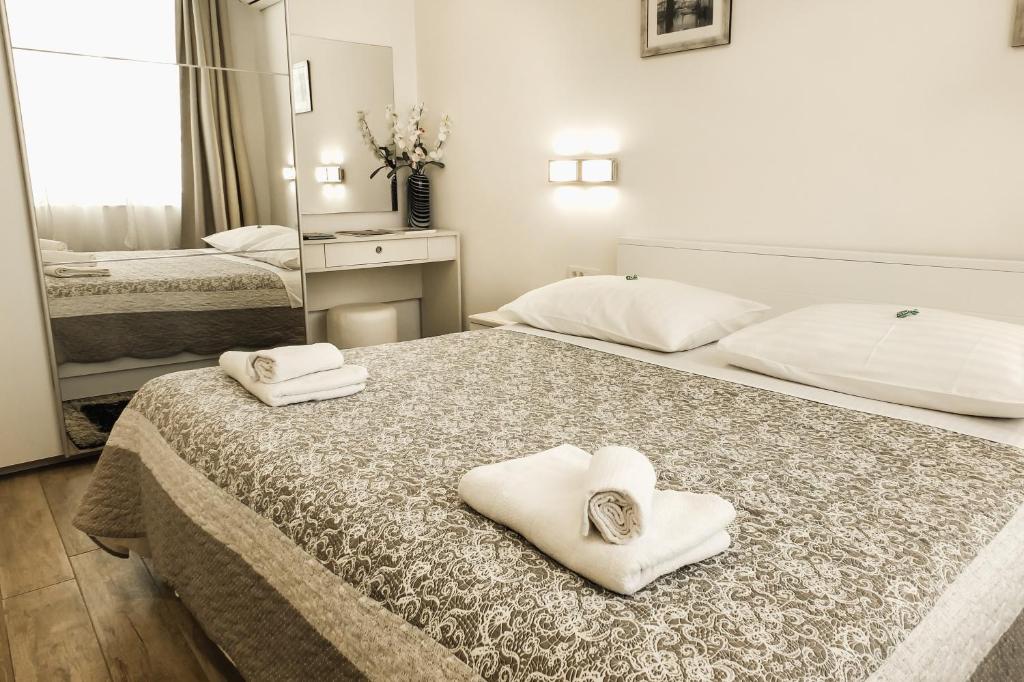 a hotel room with two beds with towels on them at Old Square Apartment in Split