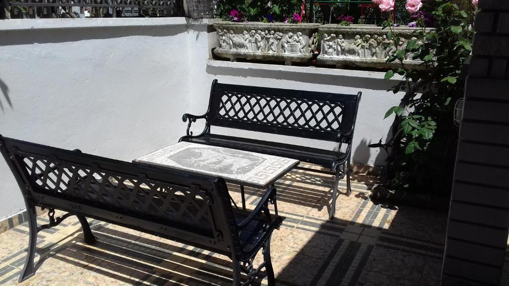 a bench with a sign on it next to a wall at Apartmani Ivona in Budva