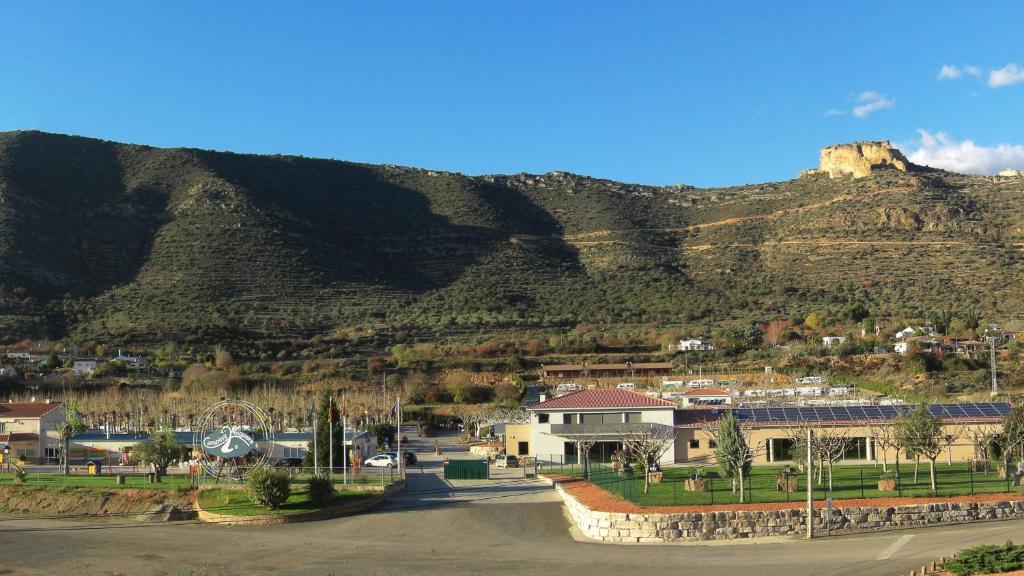 a town with a mountain in the background at La Noguera Camping in Sant Llorenç de Montgai