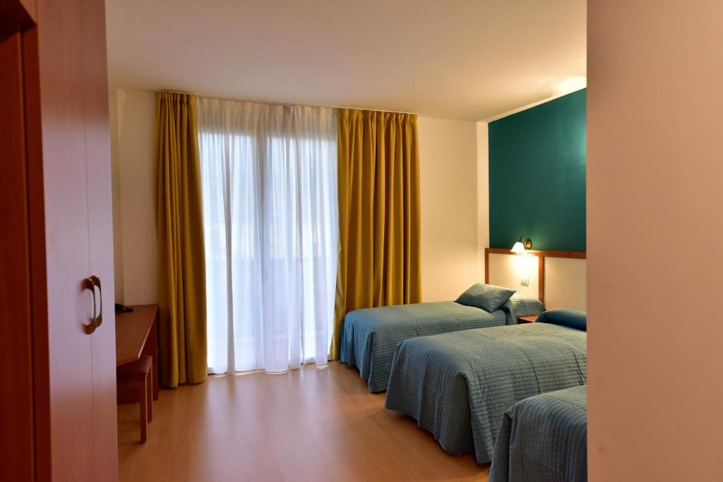 Postel nebo postele na pokoji v ubytování Hotel La Pieve