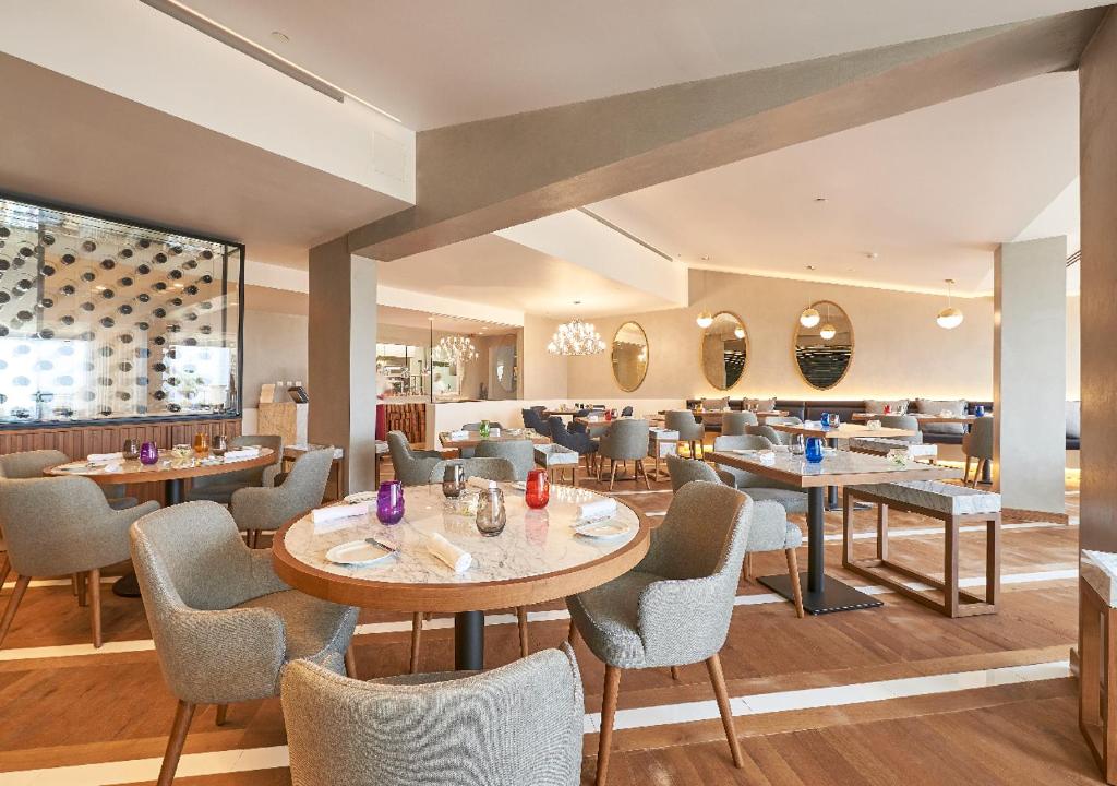 a restaurant with tables and chairs and a bar at Cascade Wellness Resort in Lagos