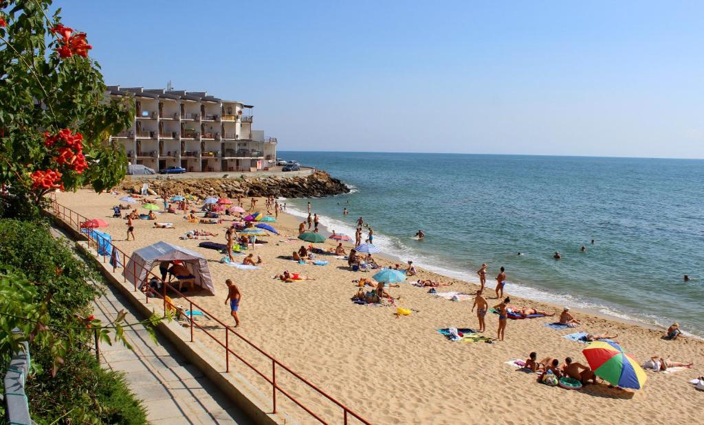 a group of people on a beach near the ocean at Sovinyon in Odesa