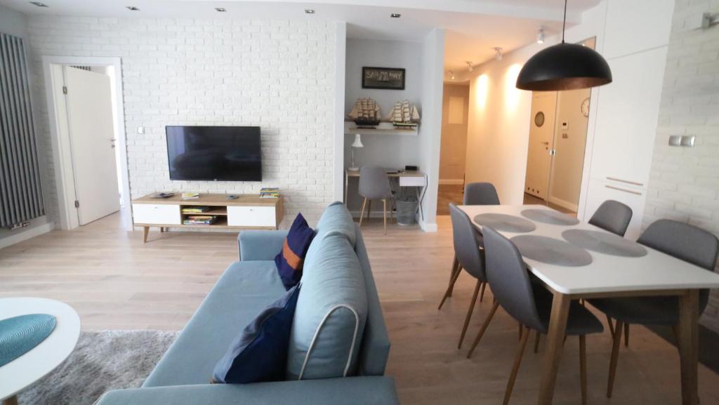 Televízia a/alebo spoločenská miestnosť v ubytovaní ASKI New Powiśle Copernicus Apartment