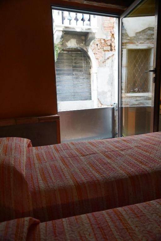 Postel nebo postele na pokoji v ubytování Casa delle gondole