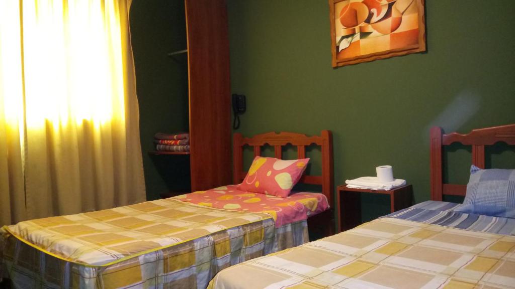 Postel nebo postele na pokoji v ubytování Hostal Residencial Mochica
