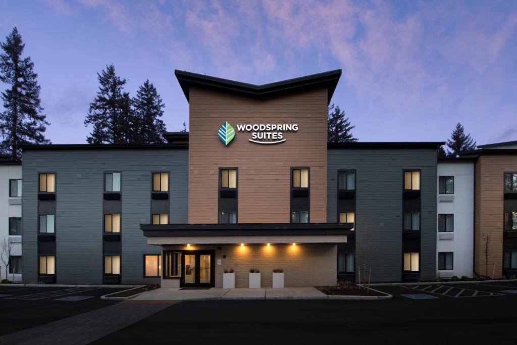 a building with the word woodworking sites on it at WoodSpring Suites Seattle Redmond in Redmond