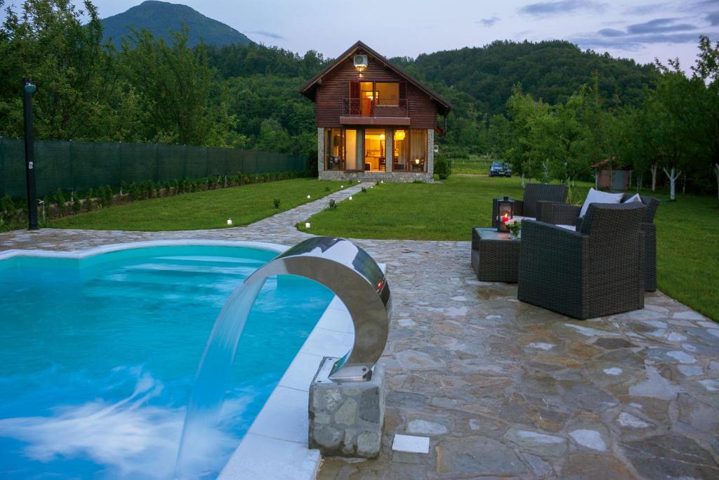 a swimming pool with a house in the background at Casa Dellˇ Amore in Bihać