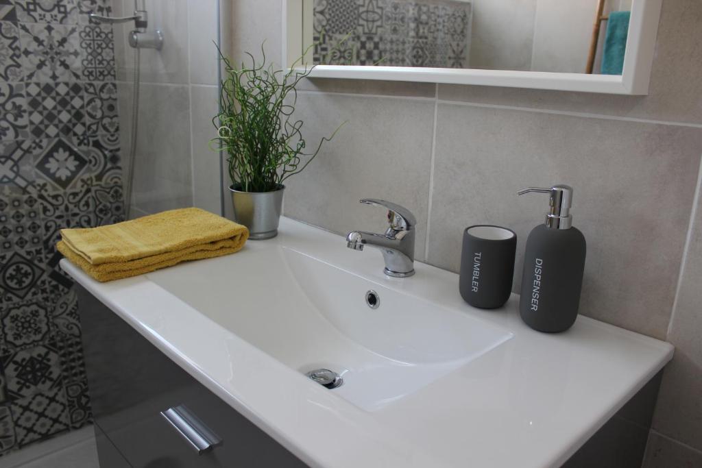 a bathroom sink with two toothbrushes on top of it at Casa da Azarujinha in Estoril