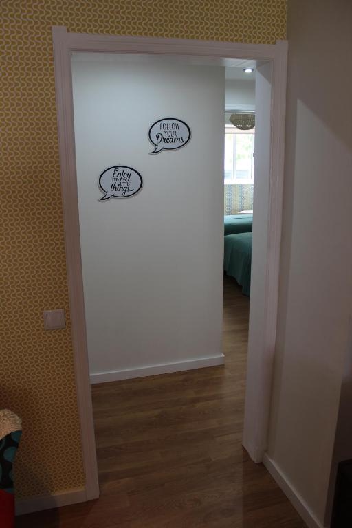 a room with two signs on a wall at Casa da Azarujinha in Estoril