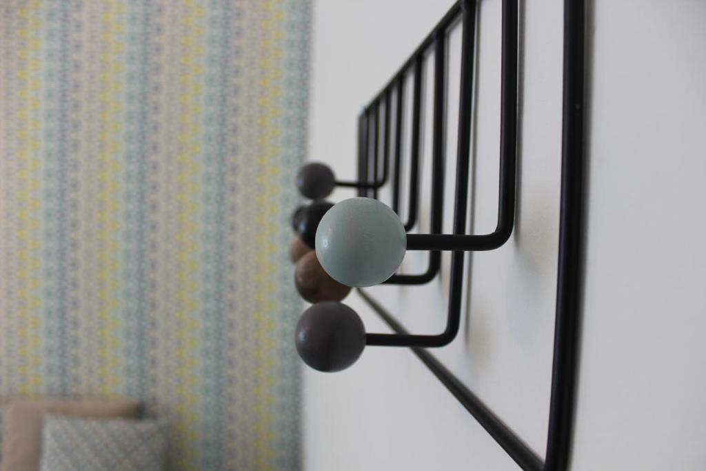 a metal object with balls attached to a door at Casa da Azarujinha in Estoril