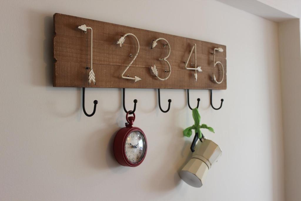 a clock on a wall next to a wall at Casa da Azarujinha in Estoril