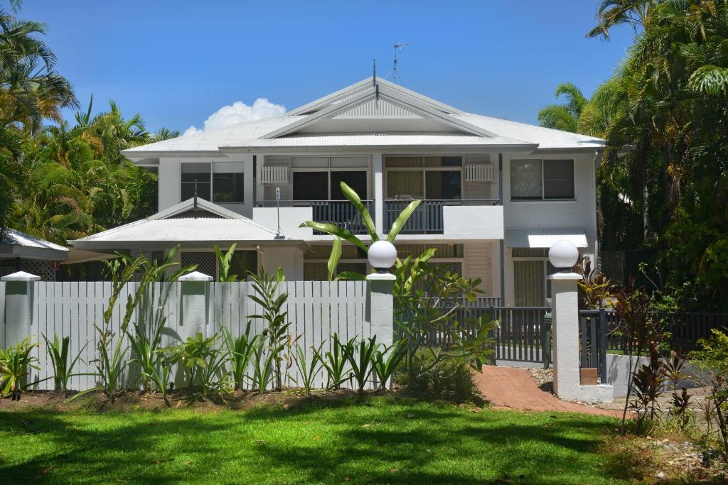 a white house with a fence in front of it at Seascape Holidays - Tropic Sands in Port Douglas