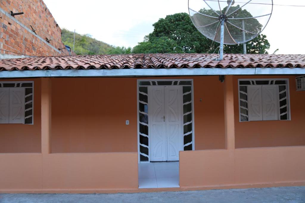 uma casa com uma roda d'água no telhado em Casa de Temporada na Orla em Canindé de São Francisco