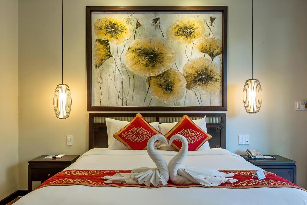 Postel nebo postele na pokoji v ubytování Hoi An Field Boutique Resort & Spa