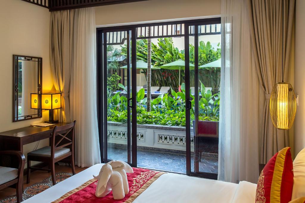 Postel nebo postele na pokoji v ubytování Hoi An Field Boutique Resort & Spa