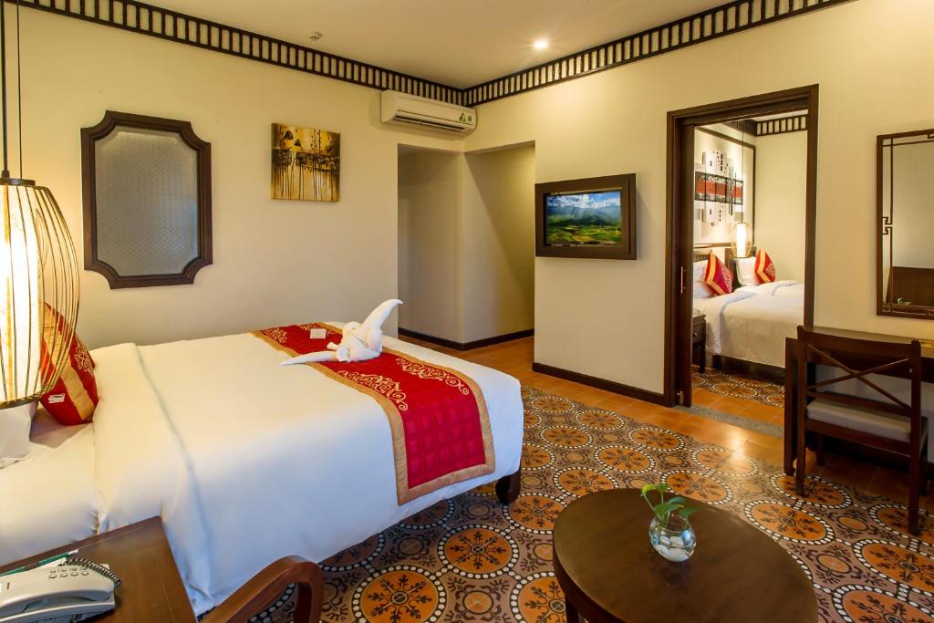 Postel nebo postele na pokoji v ubytování Hoi An Field Boutique Resort & Spa