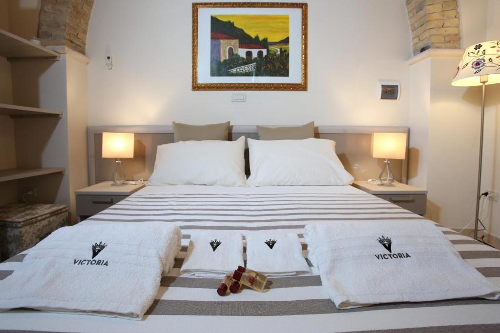 a bedroom with a bed with two towels on it at Victoria Royal Apartments in Termoli