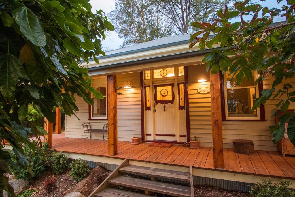 a front porch of a house with a wooden deck at The Oaks Lilydale Accommodation in Lilydale