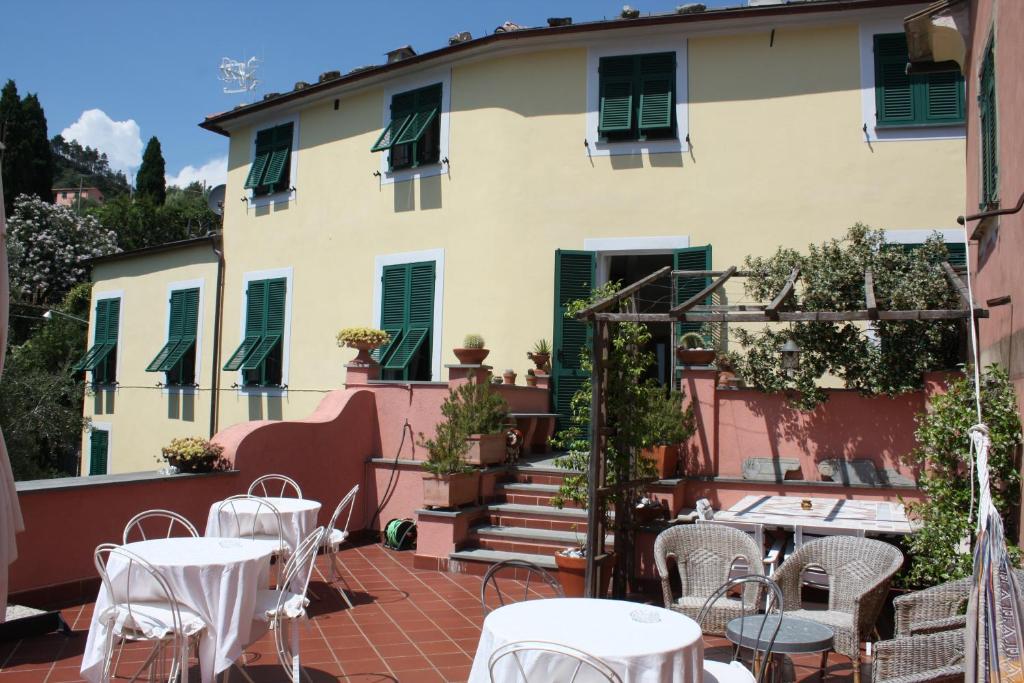 a patio with tables and chairs in front of a building at L'Antico Borgo B&B in Levanto