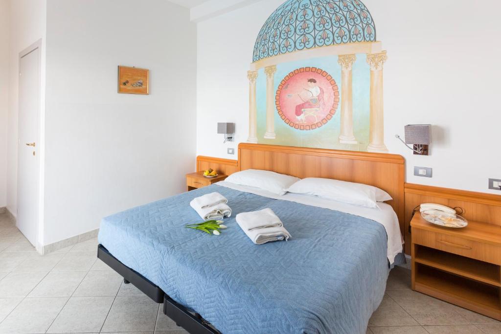 Postel nebo postele na pokoji v ubytování Hotel CasaDei