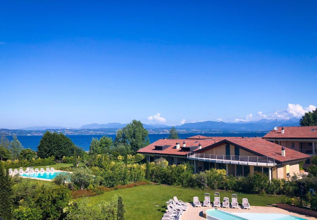 a resort with a swimming pool and a building at Paradise Luxury apartments in Sirmione