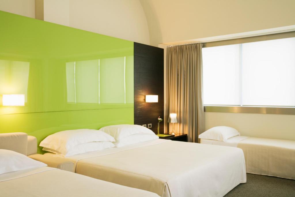Postel nebo postele na pokoji v ubytování UNA HOTELS T Hotel Cagliari