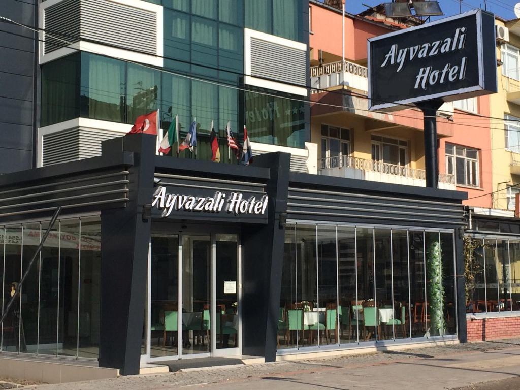a hotel with flags on the front of it at Ayvazali Hotel in Bergama