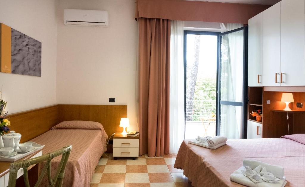 Postel nebo postele na pokoji v ubytování Hotel Maita