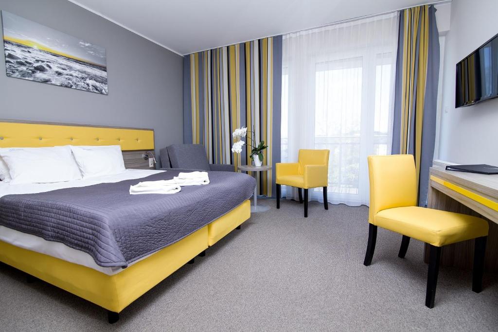 Postel nebo postele na pokoji v ubytování Hotel Jastarnia