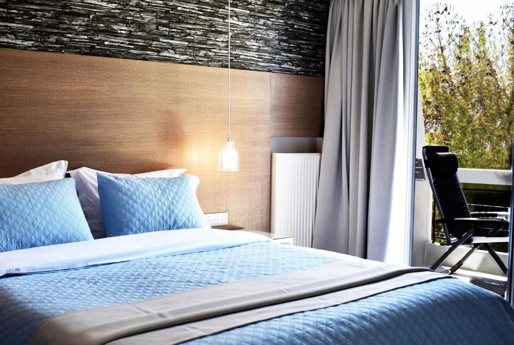Postel nebo postele na pokoji v ubytování Karystion Hotel