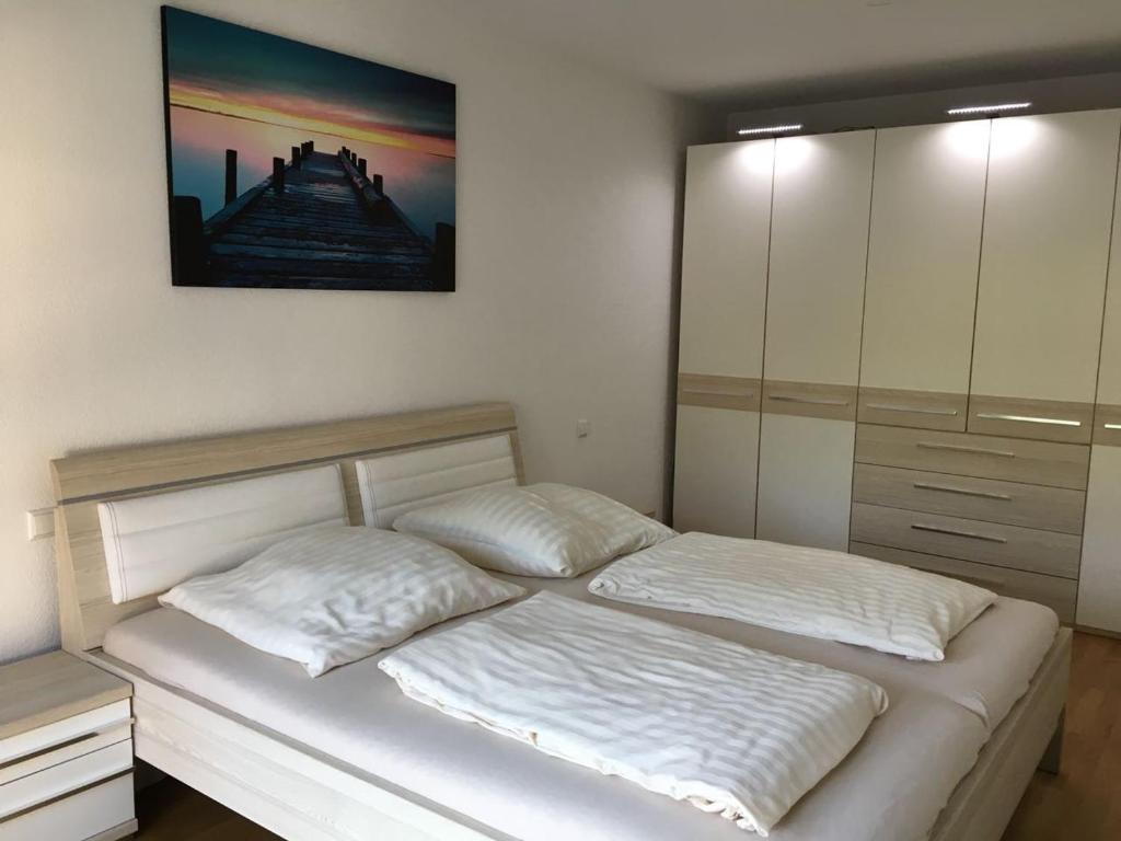a bedroom with two beds and a painting on the wall at Diana in Lahr