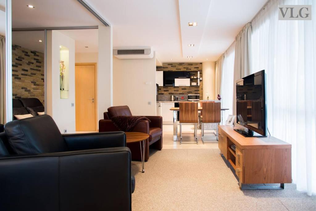 a living room with a couch and a tv at Old Riga Modern Apartment in Riga