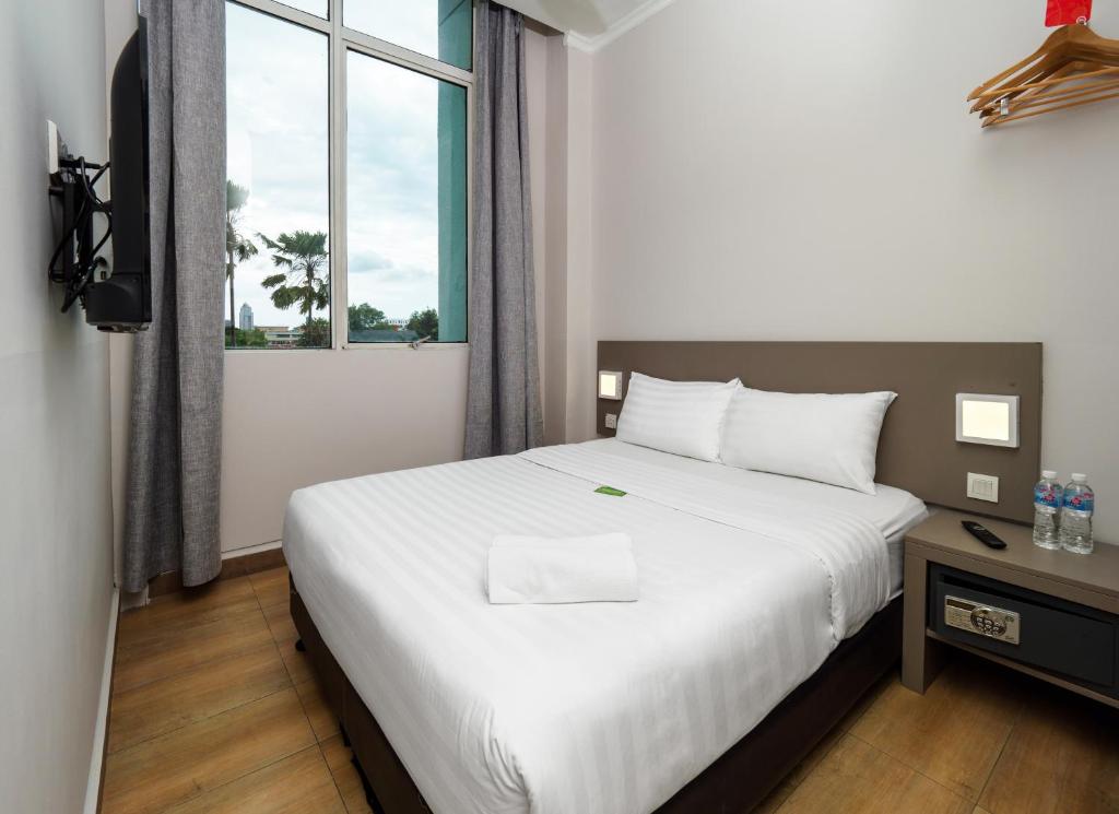Postel nebo postele na pokoji v ubytování Tune Hotel - 1Borneo Kota Kinabalu