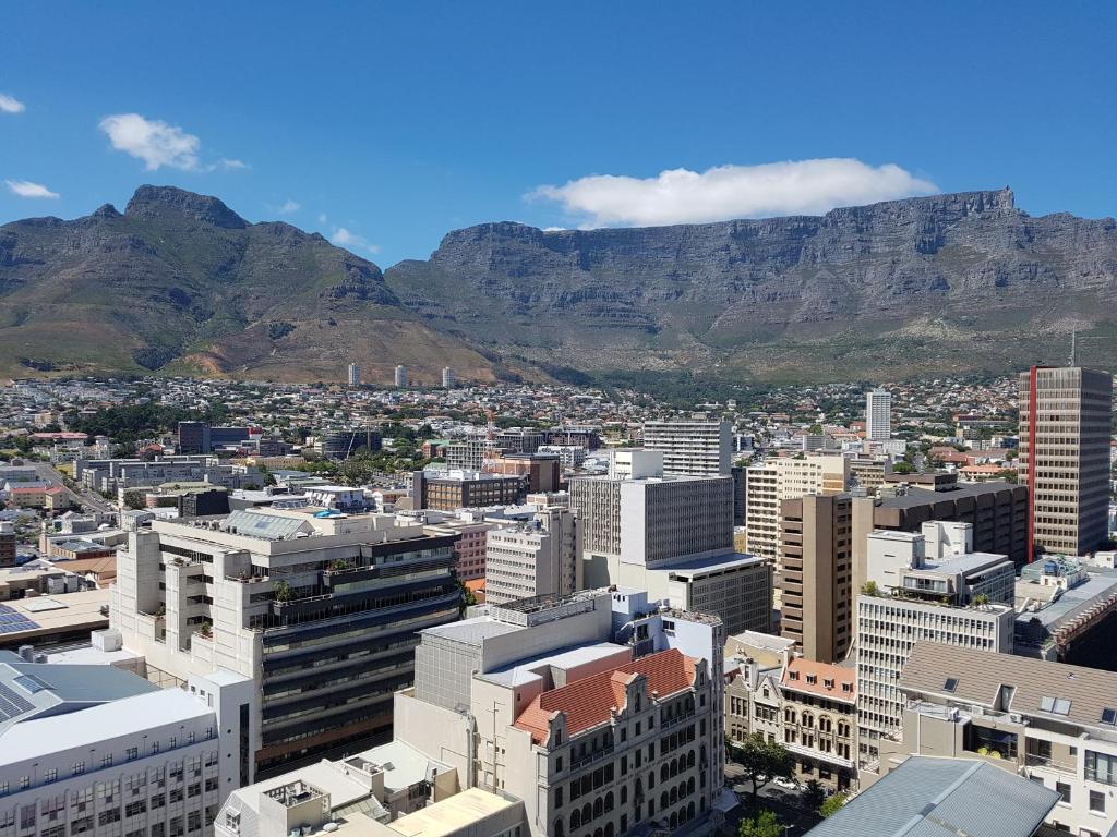 a view of cape town with table mountain in the background at Cartwrights CNR 2 Bed Apartments in Cape Town