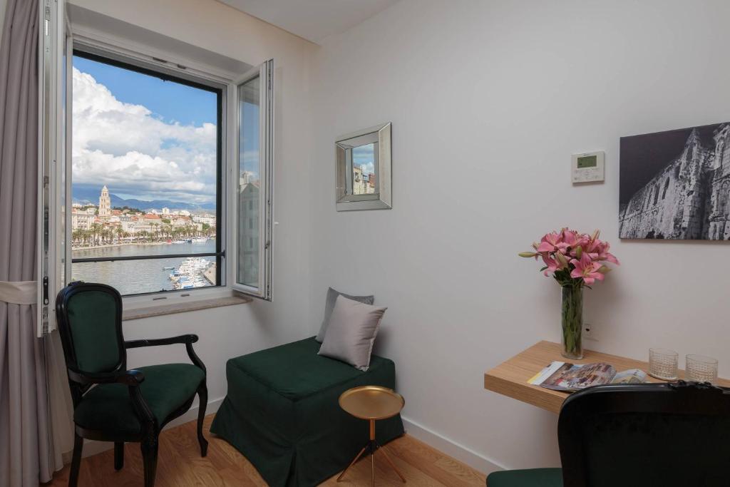 a room with a desk and a chair and a window at Belvedere Luxury Rooms - Breathtaking View in Split